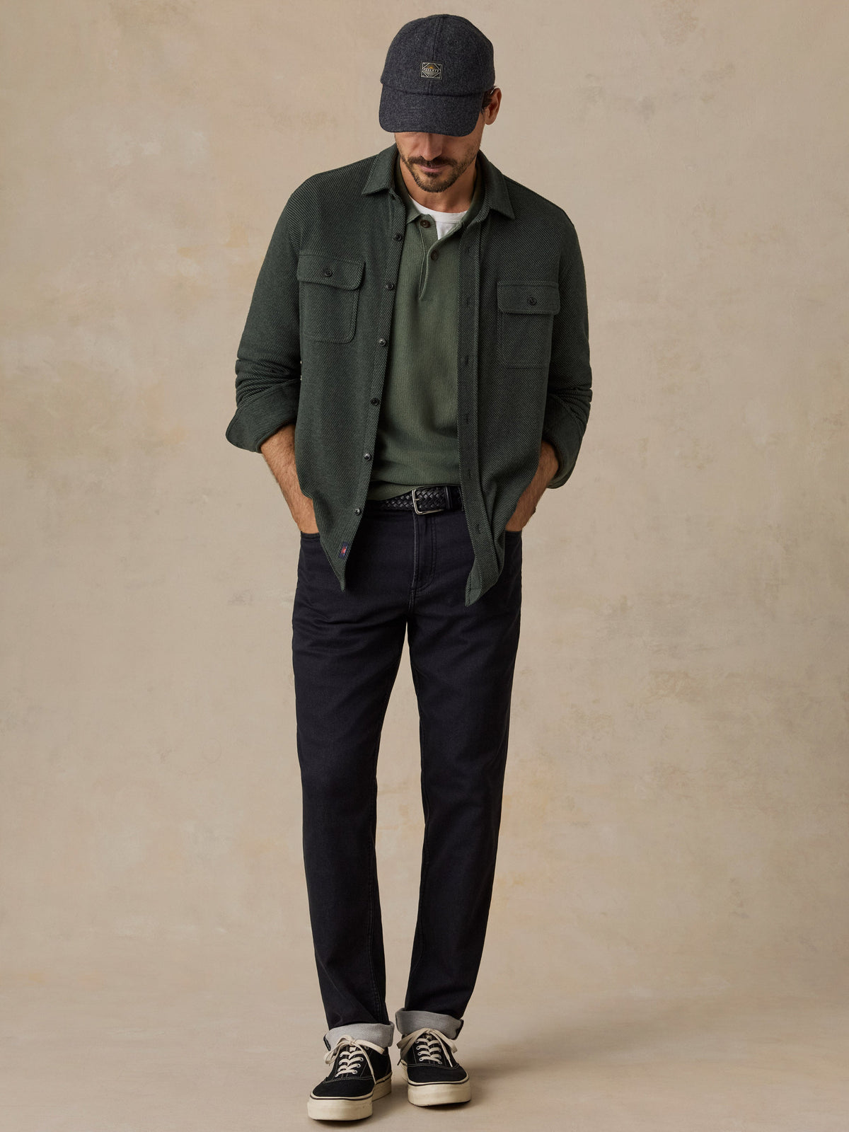 Man wearing Faherty Legend Sweater Shirt in dark green twill with dark jeans and sneakers