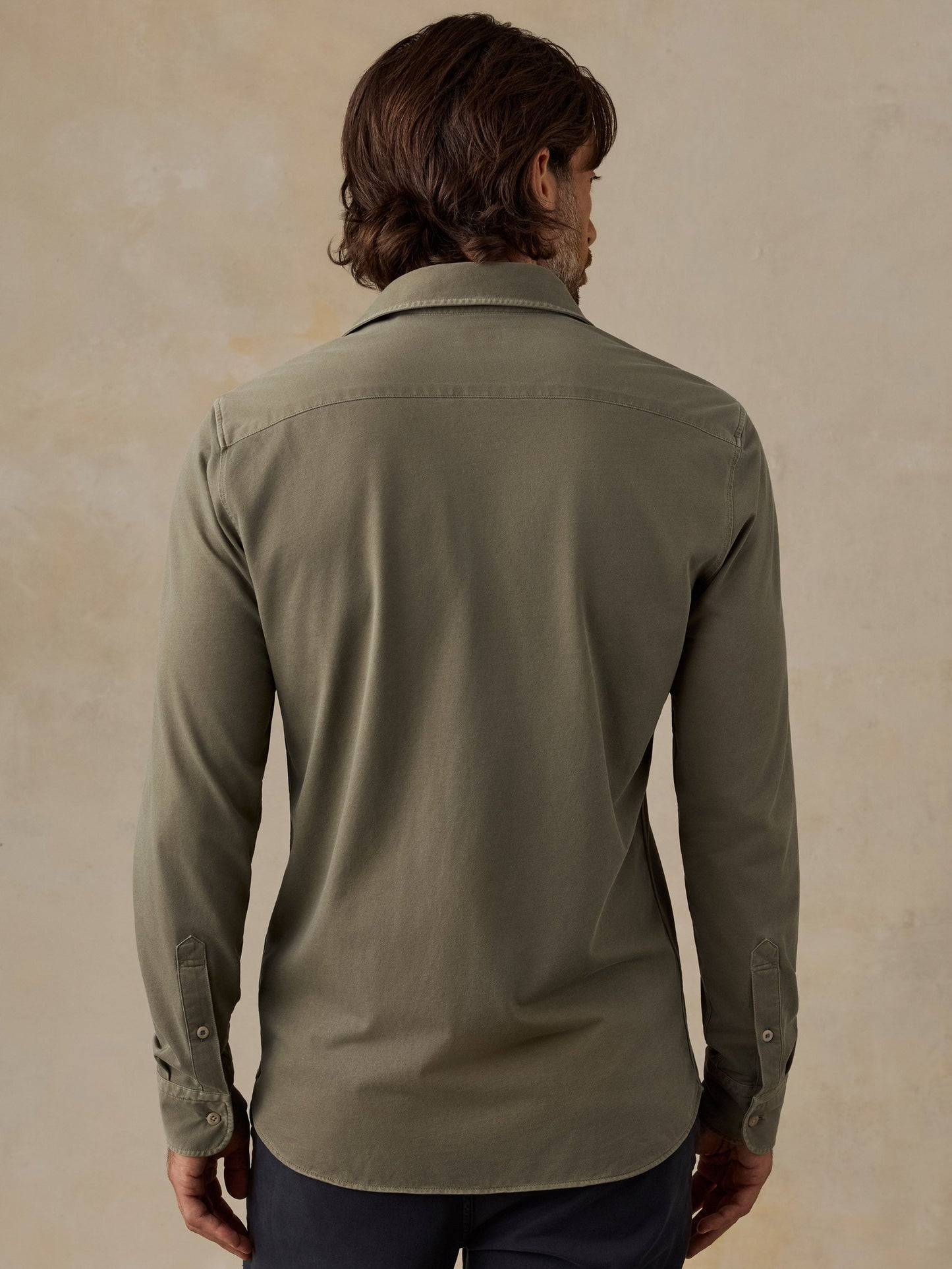 Back view of man wearing Faherty Costa Piqué Shirt in Ridge Olive long sleeve