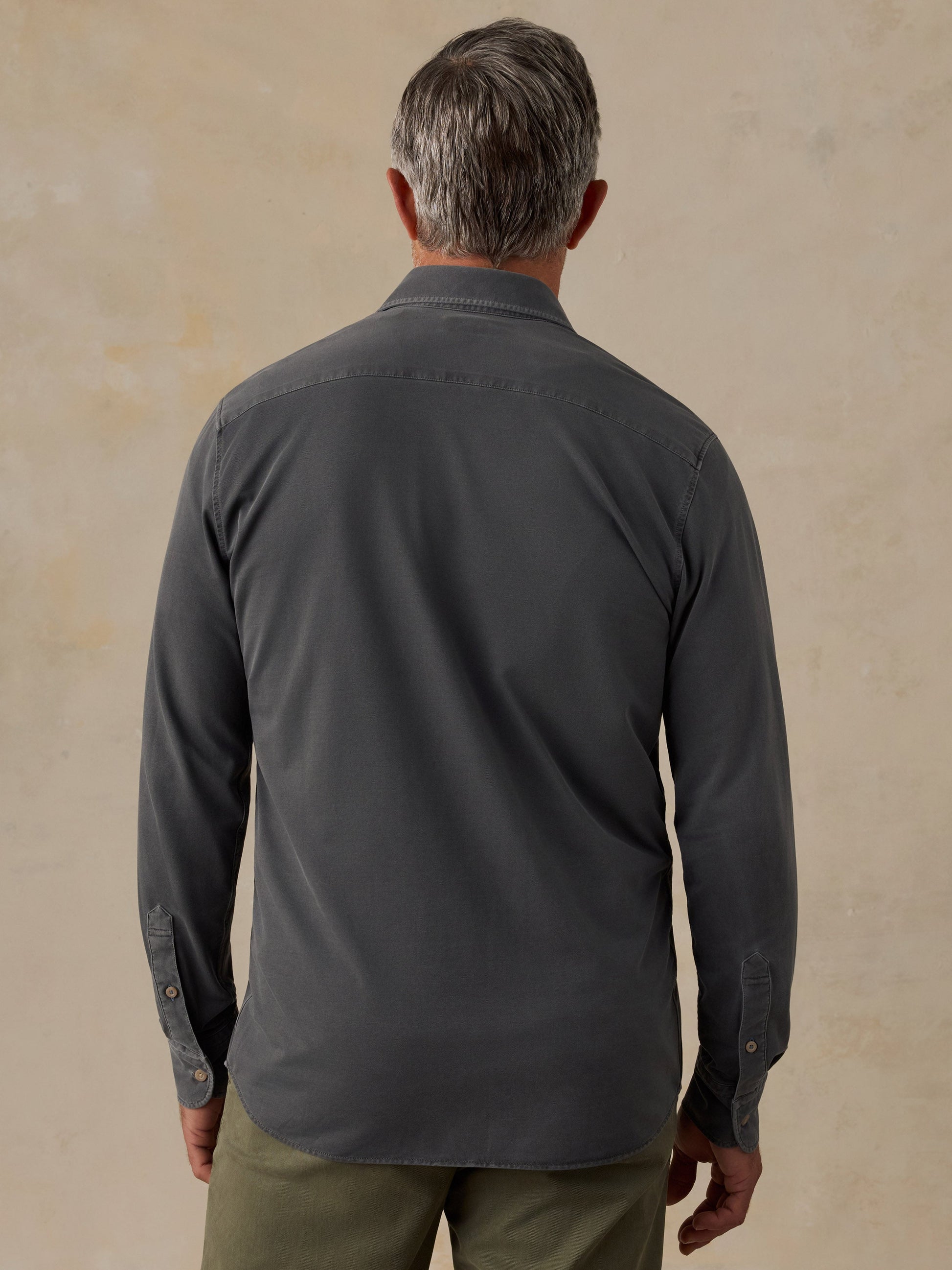 Back view of man wearing Faherty Costa Piqué Shirt in dark charcoal Ridge Black