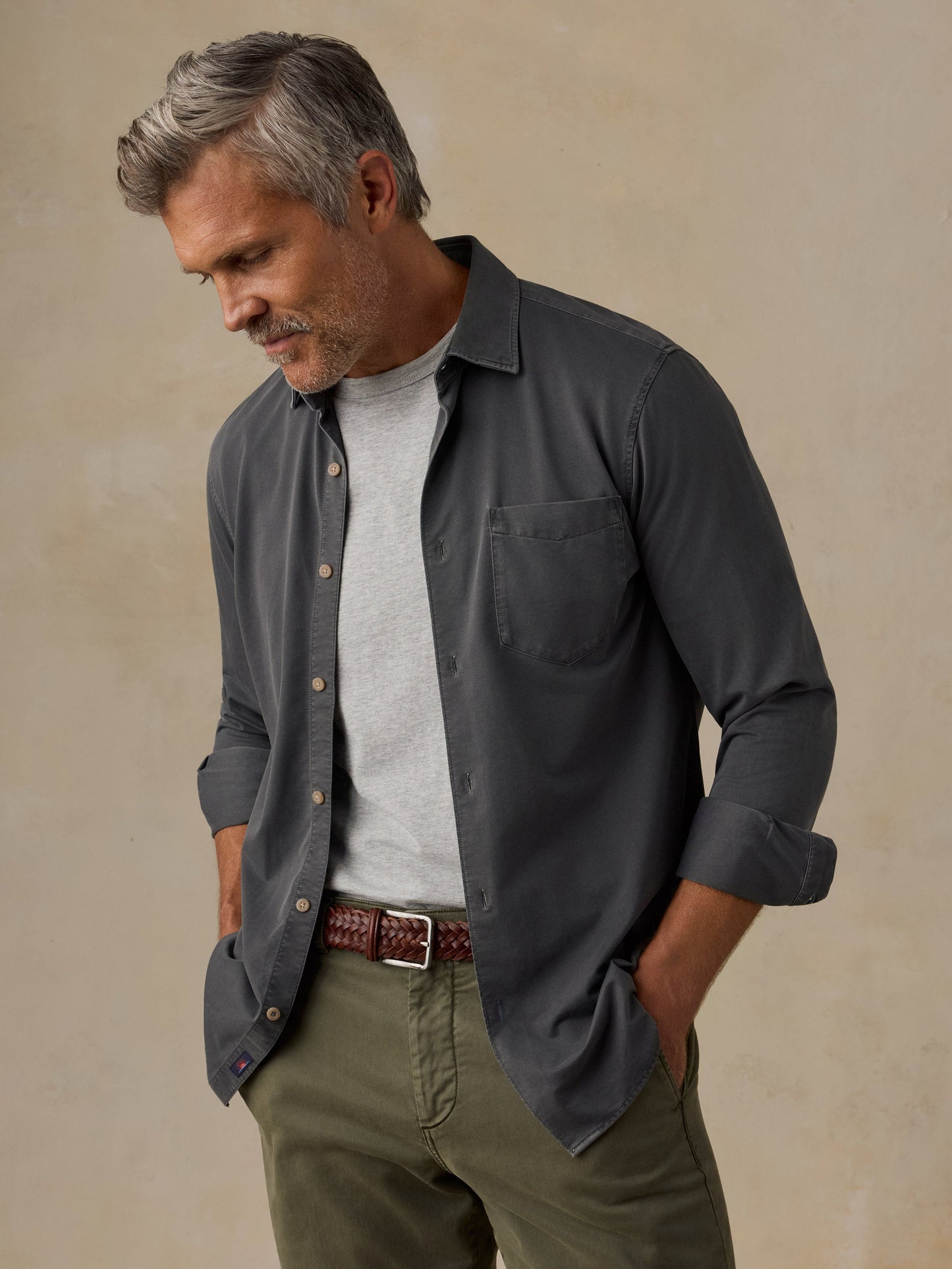 Male model wearing Faherty Costa Piqué Shirt in dark charcoal Ridge Black, open over grey tee