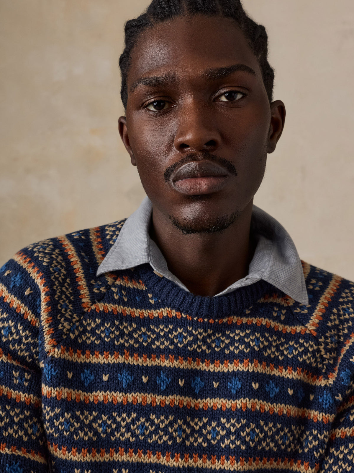 Male model wearing Faherty Nordic Sweater Crew in Northern Nights Fairisle pattern with layered collar
