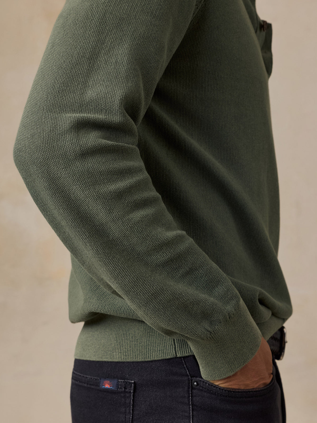 Close-up detail of Faherty Lightweight Sunwashed Sweater Polo in Mountain Green with textured knit