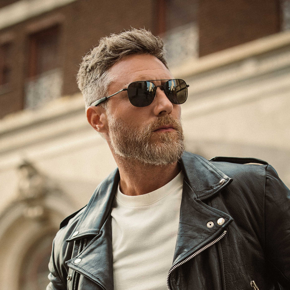 Man wearing Randolph Aviator Military Special Edition matte black sunglasses with leather jacket