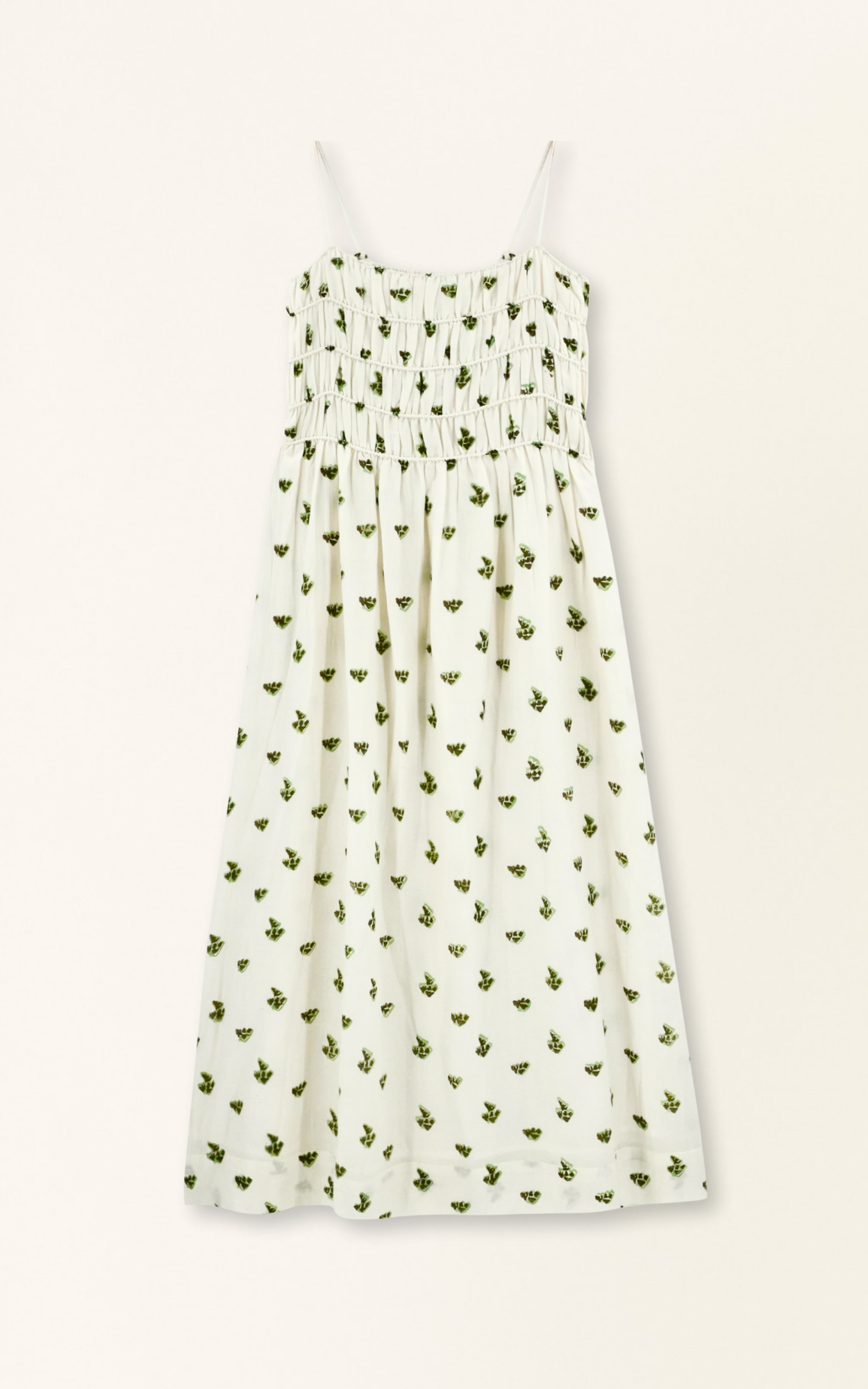 White sleeveless midi dress with green botanical print pattern and smocked bodice