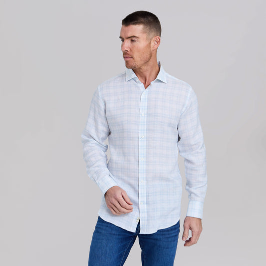 Man wearing white and teal checkered linen dress shirt with blue jeans