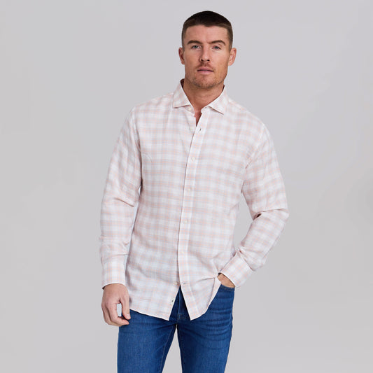 Man wearing peach and light blue plaid stretch linen sport shirt with jeans
