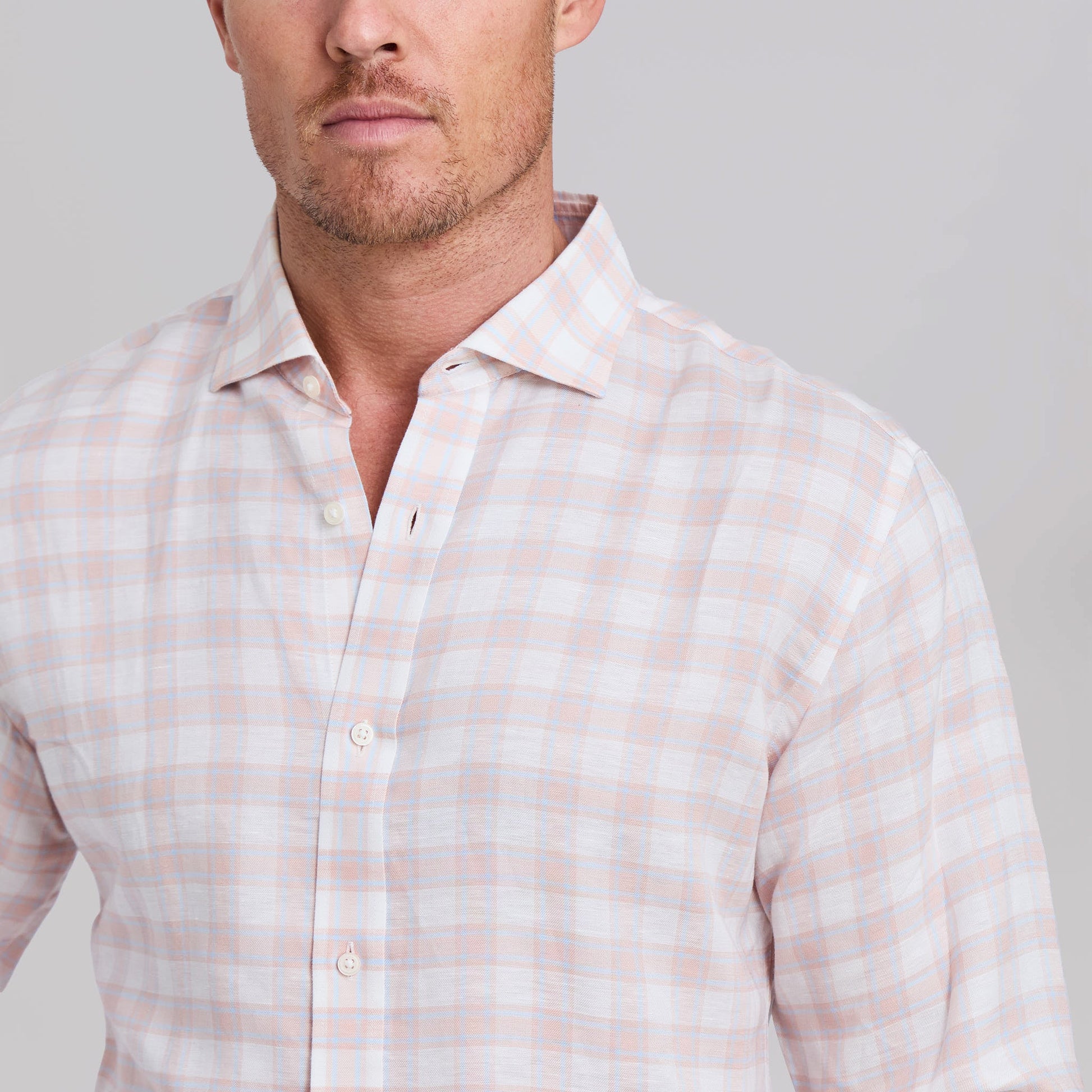 Man wearing peach and light blue plaid stretch linen dress shirt