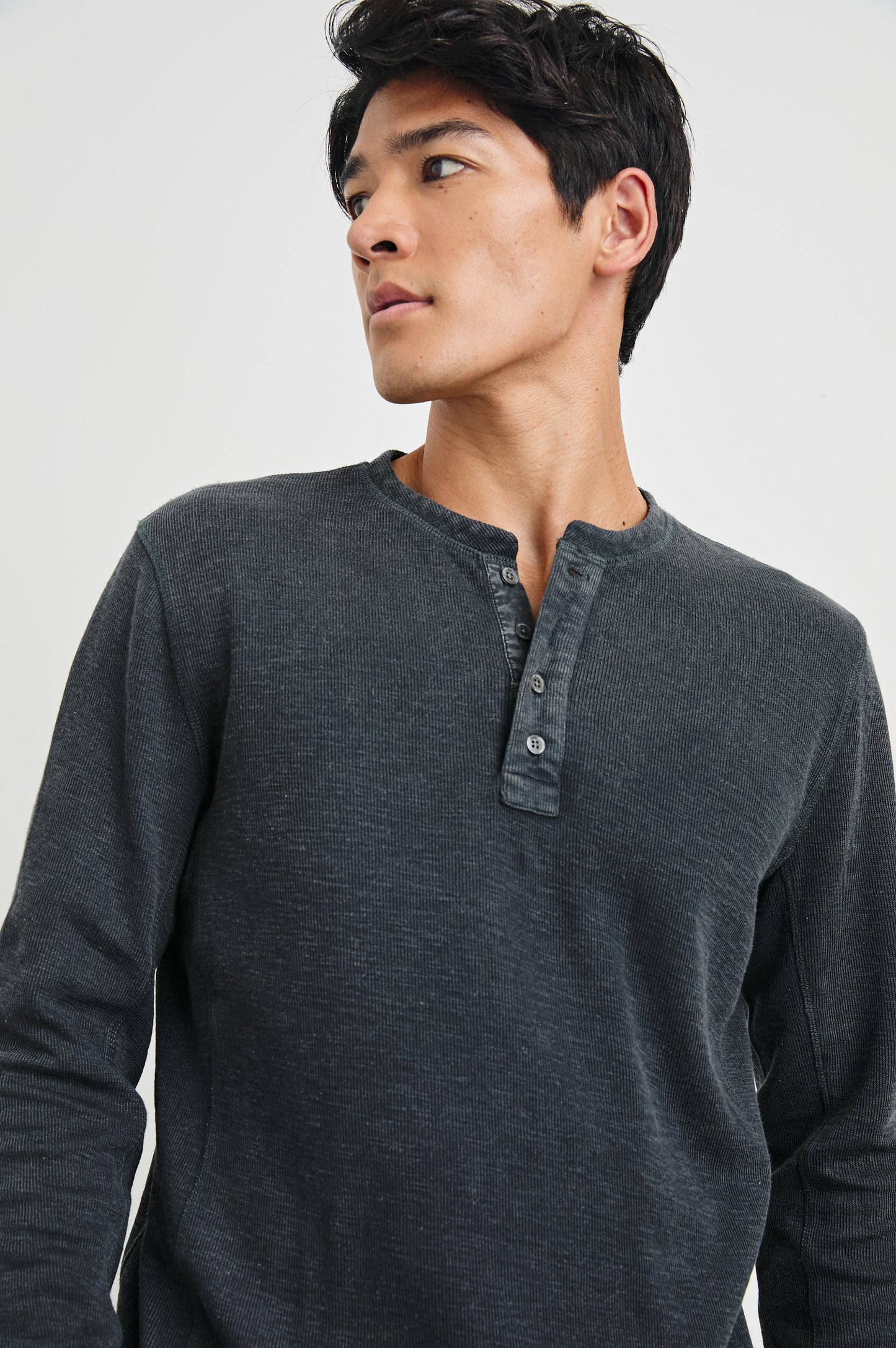 Male model wearing Rails Soto long-sleeve henley in washed black ribbed fabric