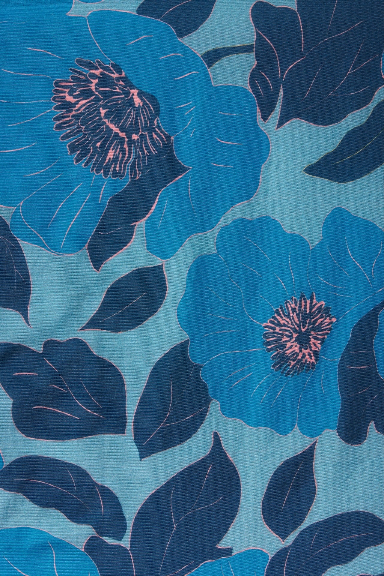 Blue floral fabric swatch with large blooms and dark leaves on light blue background