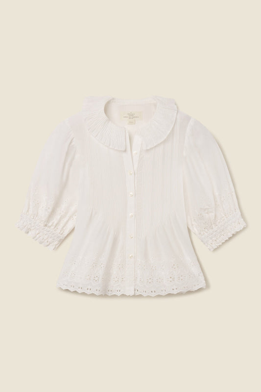 White eyelet cotton blouse with button front, three quarter sleeves, and scalloped hem