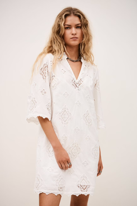 ba&sh Malo white lace dress with eyelet embroidery, three-quarter sleeves, and V-neckline on model