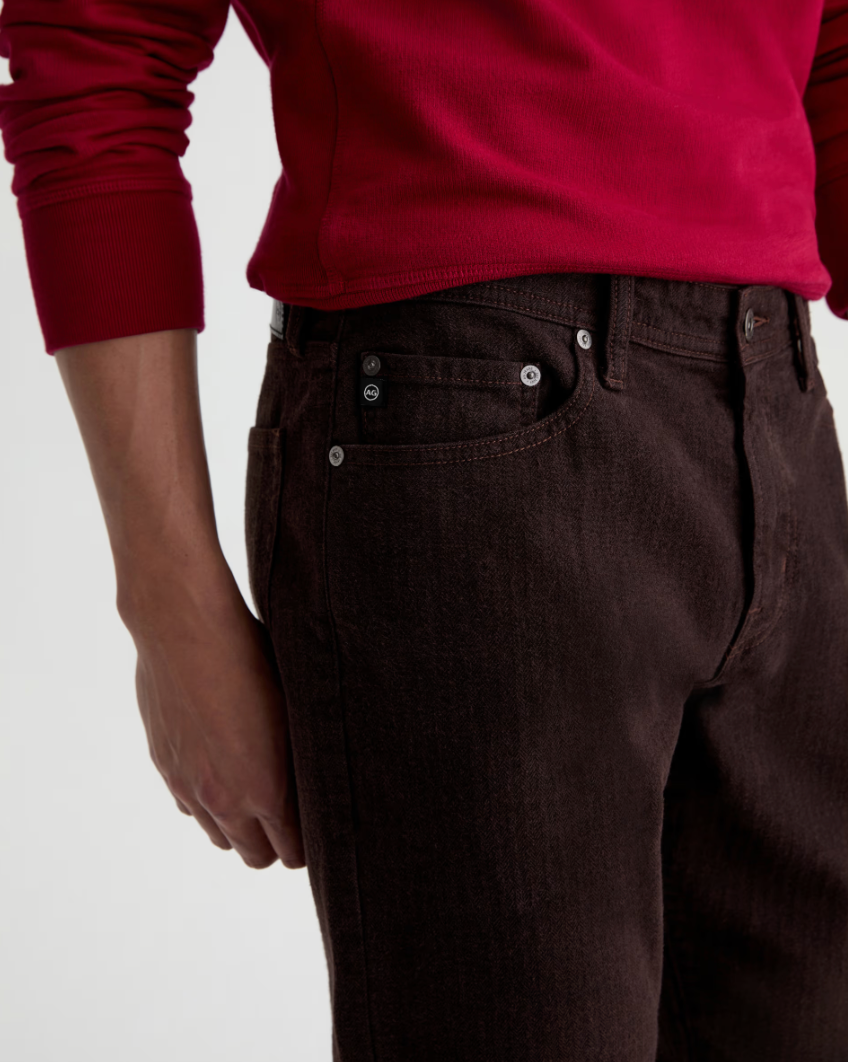 AG Everett straight-fit brown denim jeans featuring classic five-pocket styling with silver rivets and branded hardware.