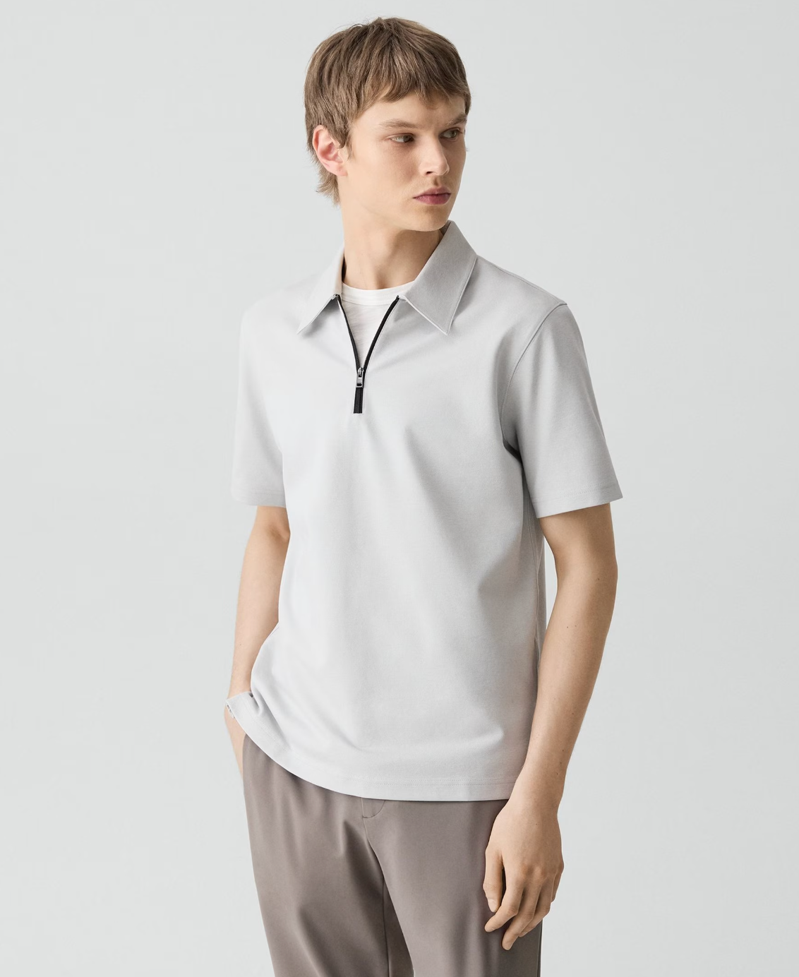 Theory men's short-sleeve zip polo shirt in light gray with collar, worn with matching trousers