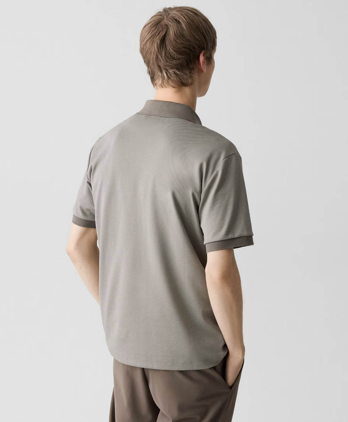 Theory Geo Polo in jacquard fabric shown from behind, featuring short sleeves and structured collar detail.