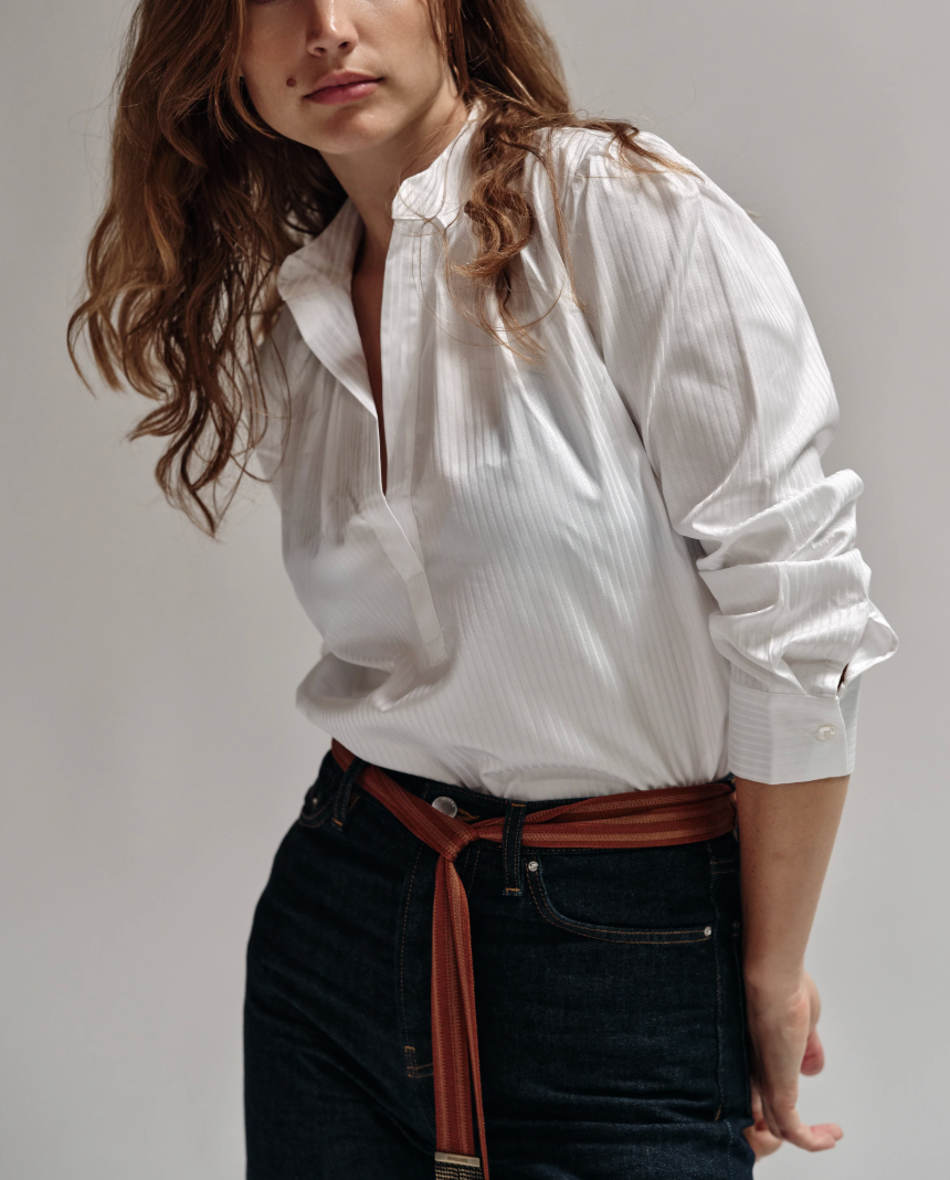 Cissa white tonal striped puff sleeve shirt with collar, styled with dark jeans and brown belt.