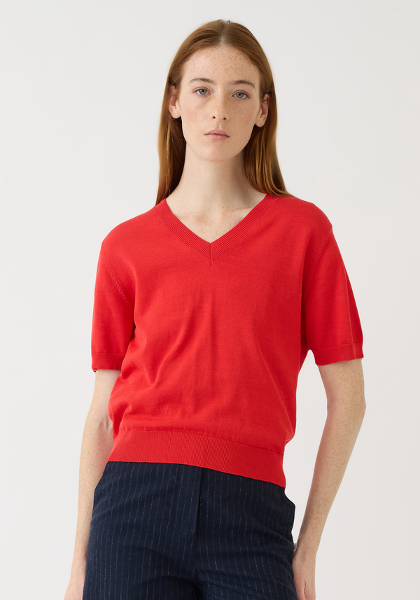 Model wearing Demylee Syd Cotton Top in vermillion red with V-neck and short sleeves