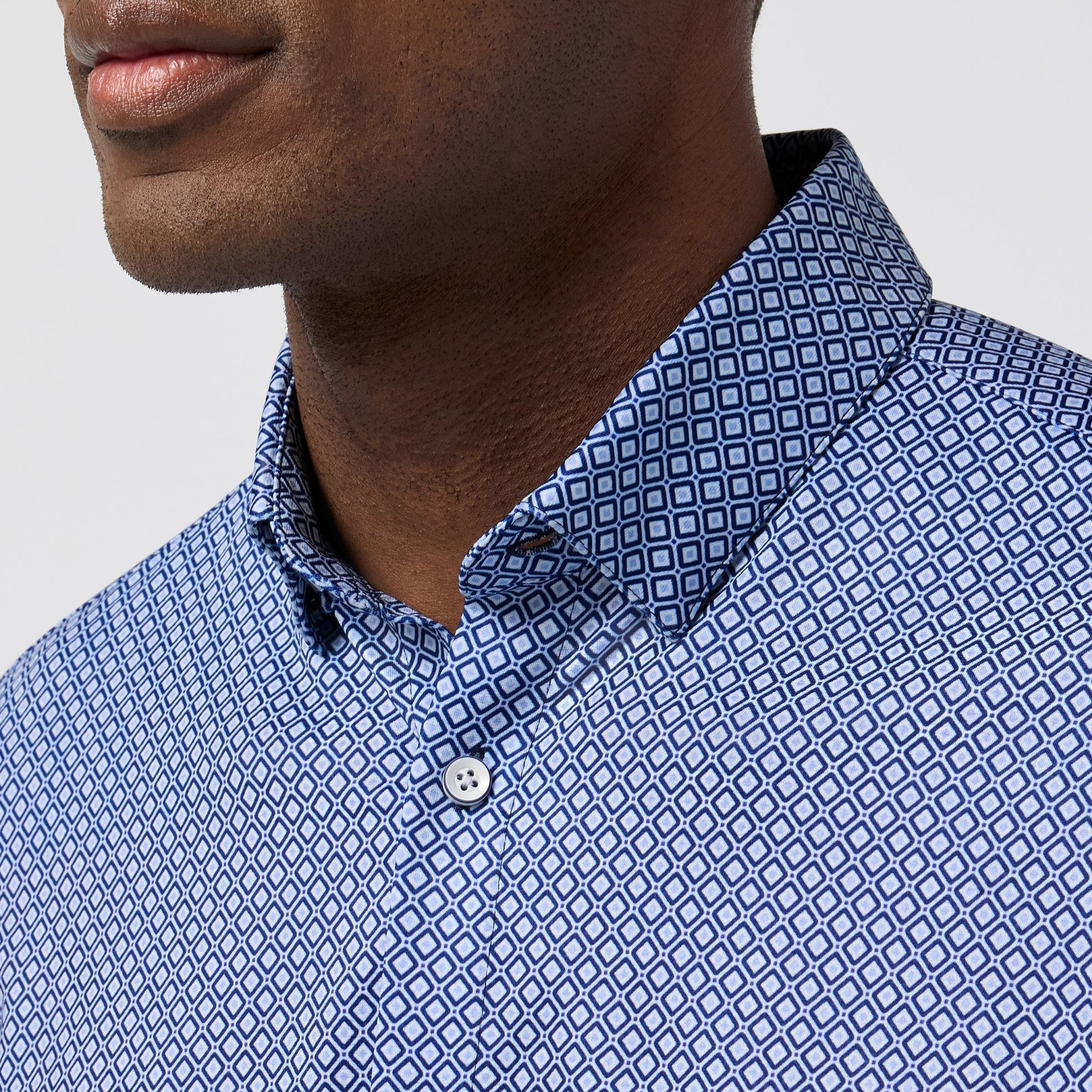 Close-up of Mizzen and Main Halyard short sleeve shirt featuring navy enlarged diamond geometric print pattern