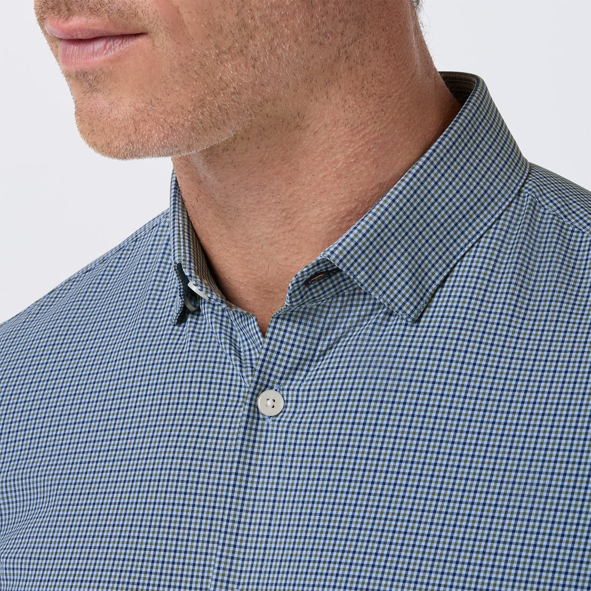 Close-up of men's navy and olive gingham plaid button-down dress shirt collar detail