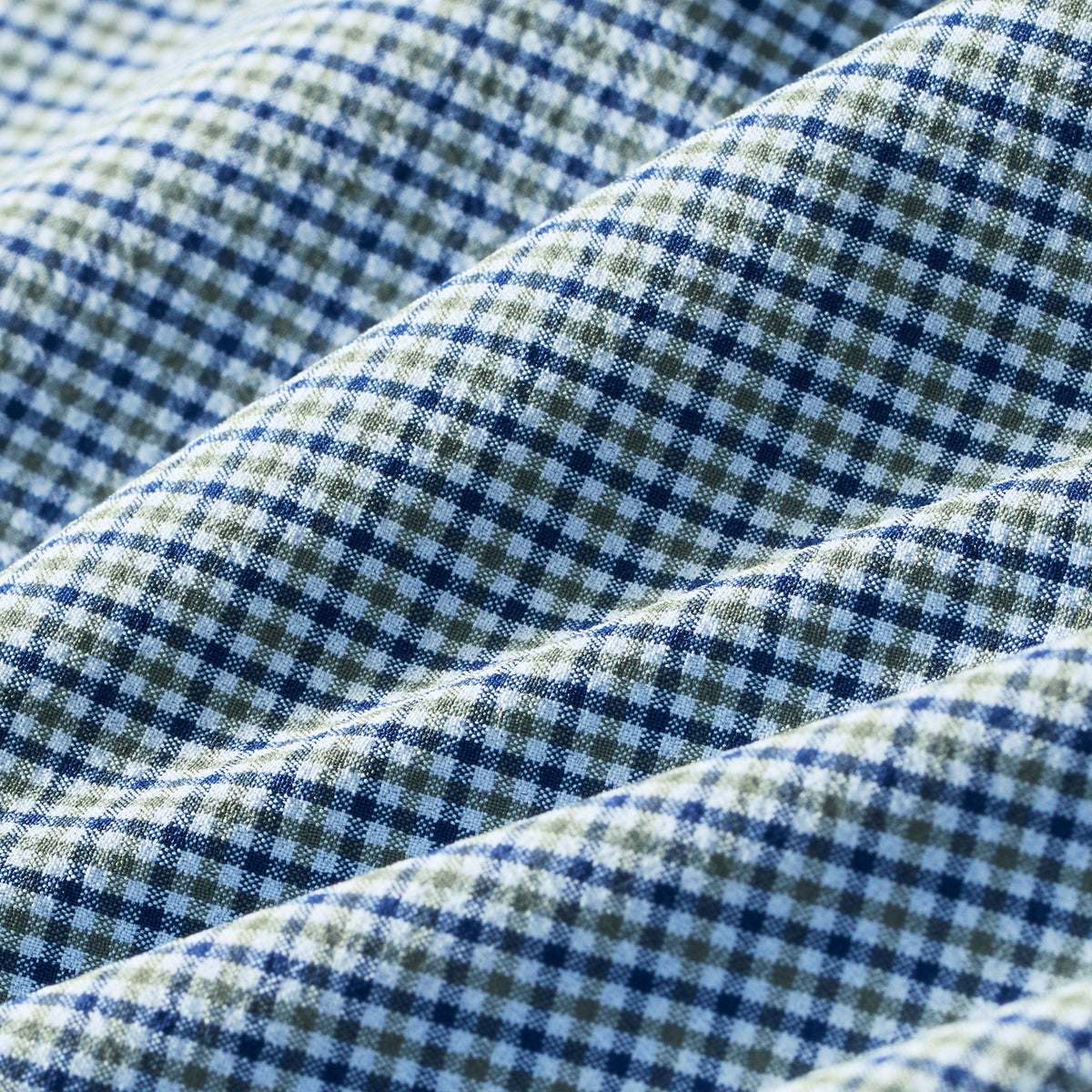 Close-up swatch of midnight navy and olive green small plaid check dress shirt fabric