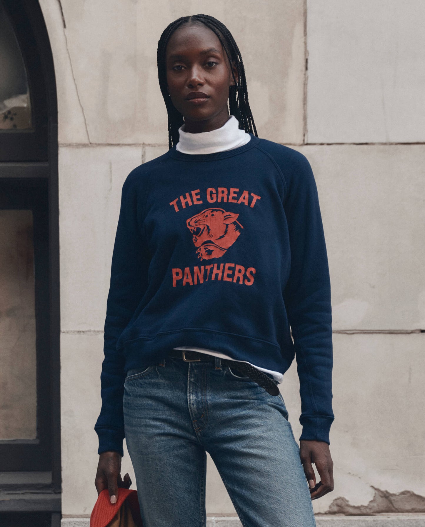 Model wearing navy 'The Great Panthers' graphic crewneck sweatshirt with jeans