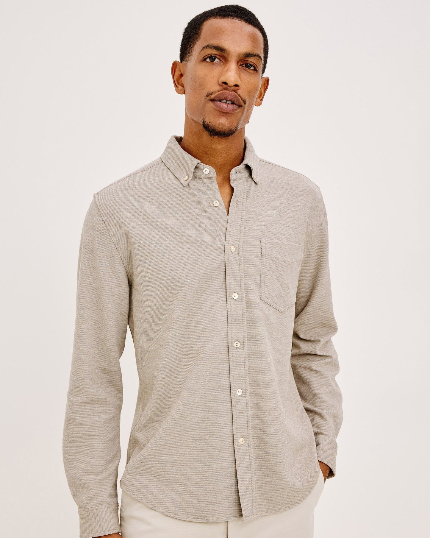Male model wearing Rails Vincent long sleeve button-down shirt in silt beige