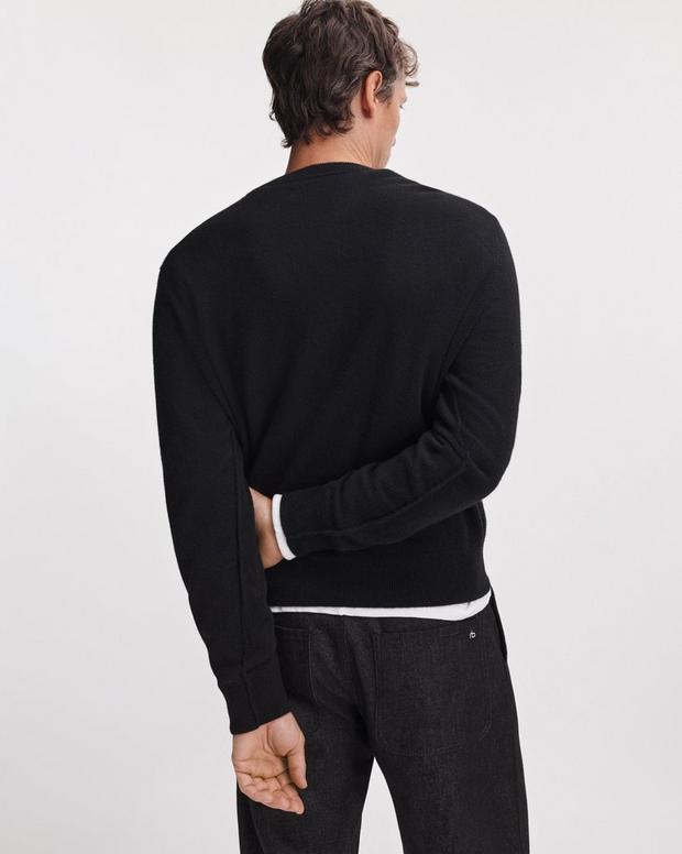 Back view of male model wearing black Vernon cashmere crew neck sweater with dark jeans