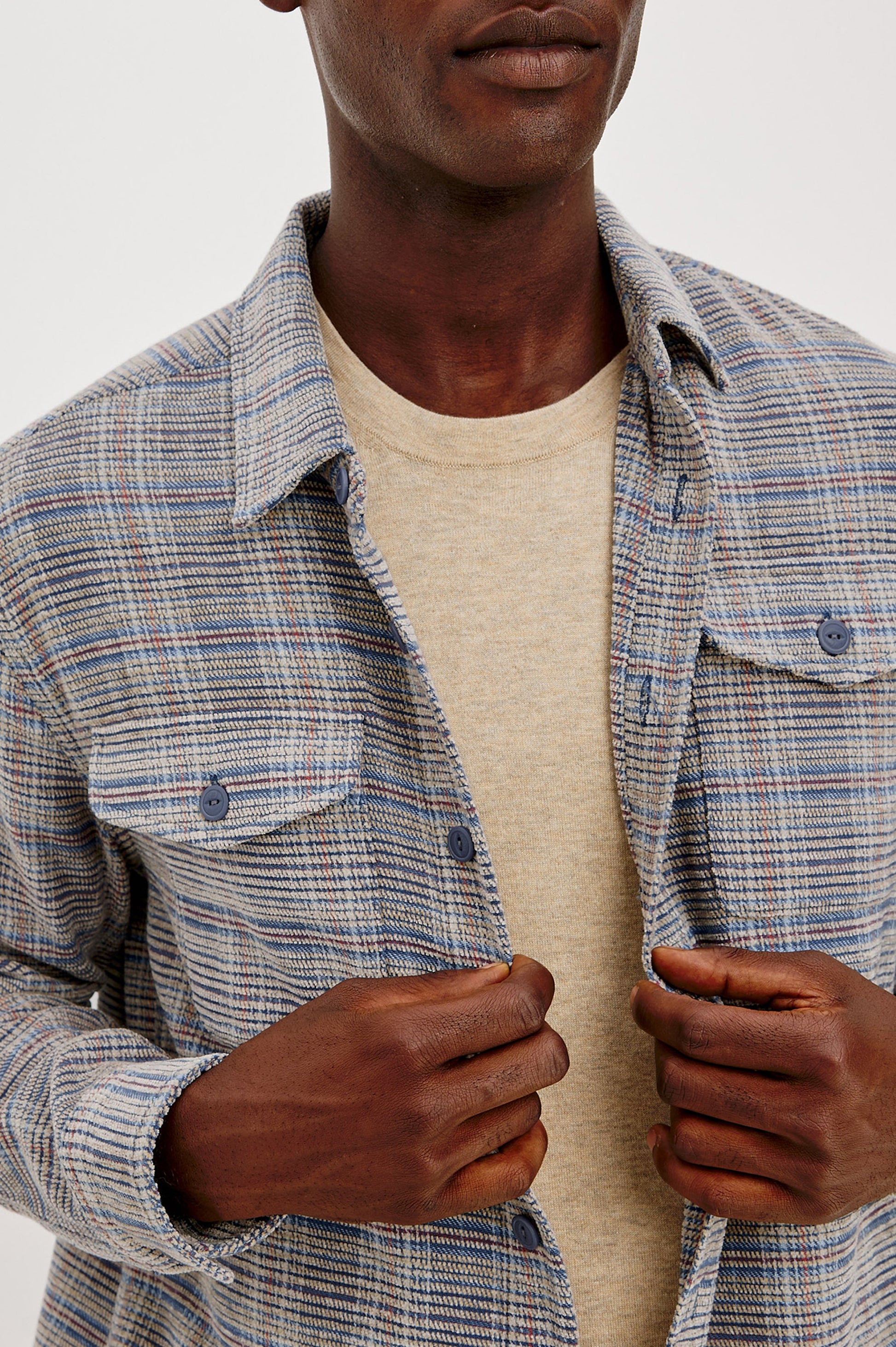 Male model wearing open Rails Warren plaid chenille overshirt in oat meridian over beige tee