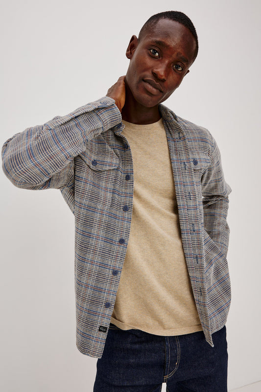 Male model wearing open Rails Warren plaid chenille overshirt in oat meridian colorway over beige tee