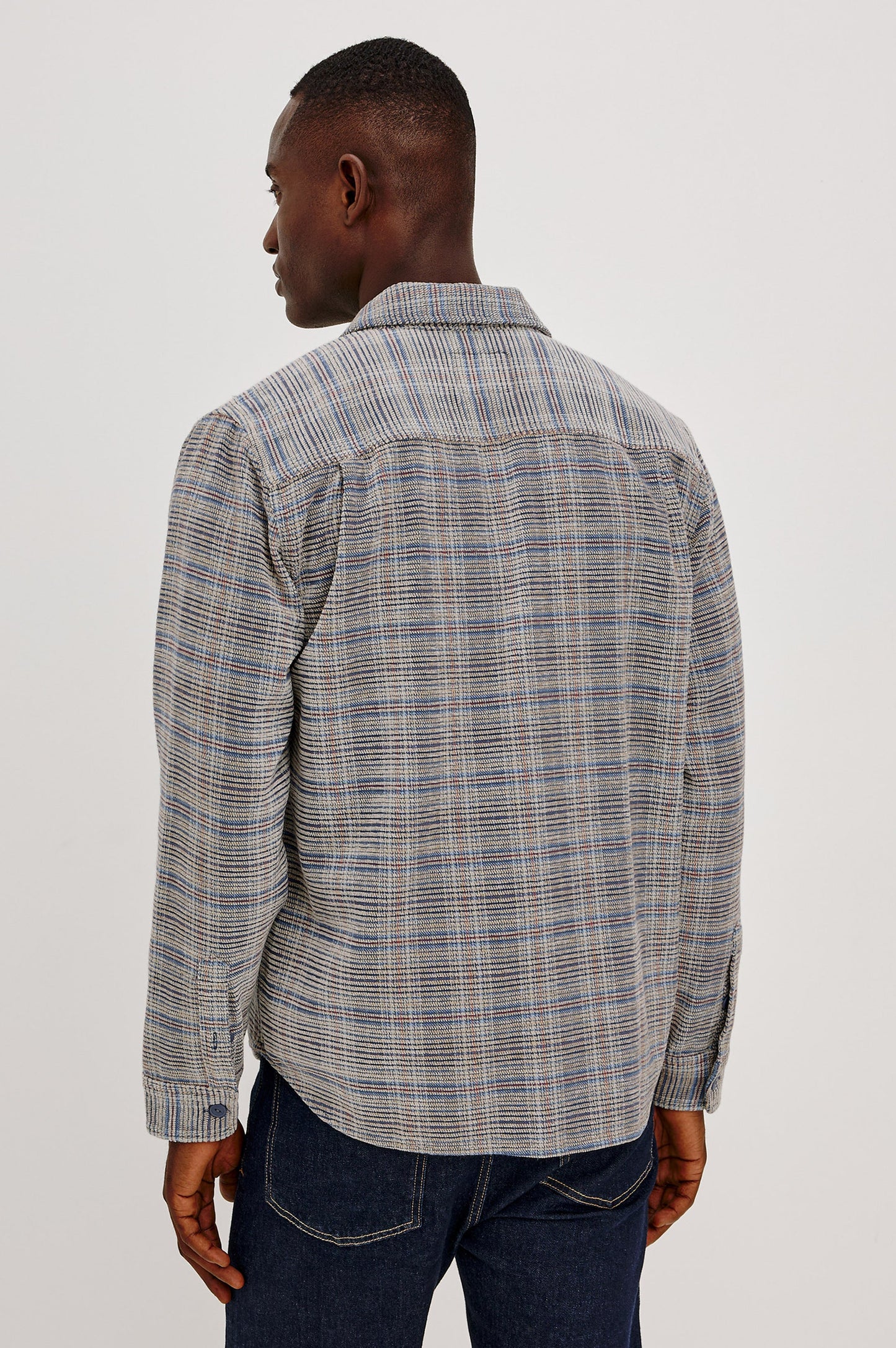 Back view of man wearing Rails Warren overshirt in oat meridian chenille plaid pattern