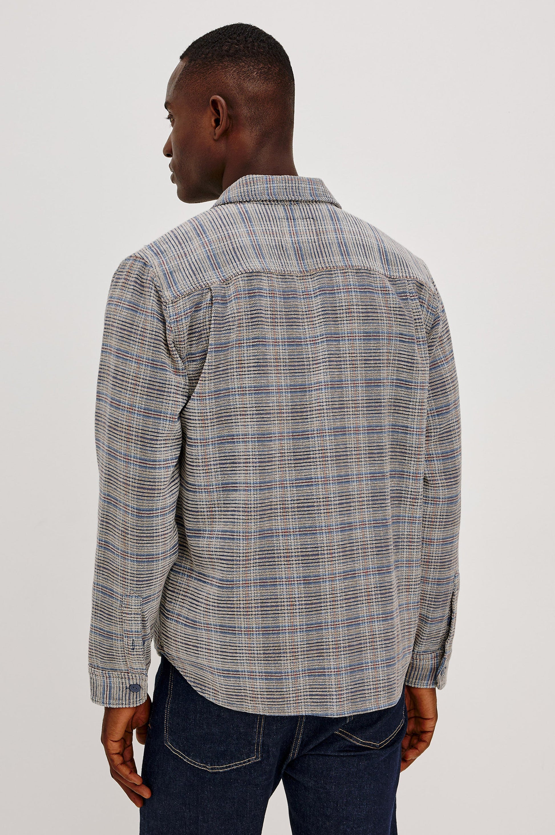 Back view of man wearing Rails Warren overshirt in oat meridian chenille plaid pattern