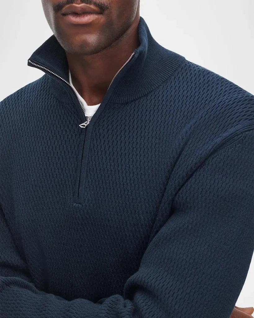 Man wearing navy waffle-knit quarter-zip sweater with silver zipper detail