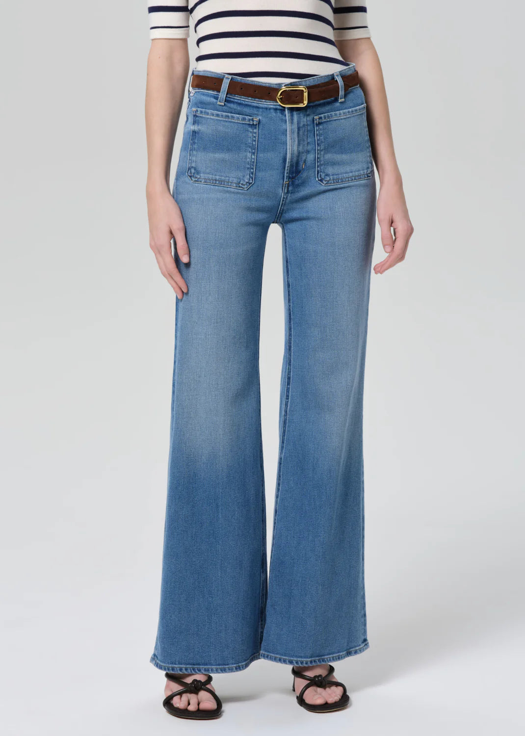 Citizens of Humanity Kimberly high-waisted flare jeans with patch pockets, styled with striped top and brown belt.