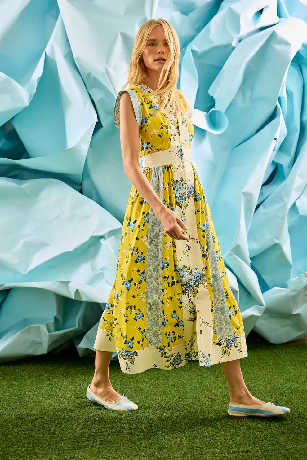 Hunter Bell April sleeveless midi dress with mixed floral and botanical print patterns in yellow and cream tones.