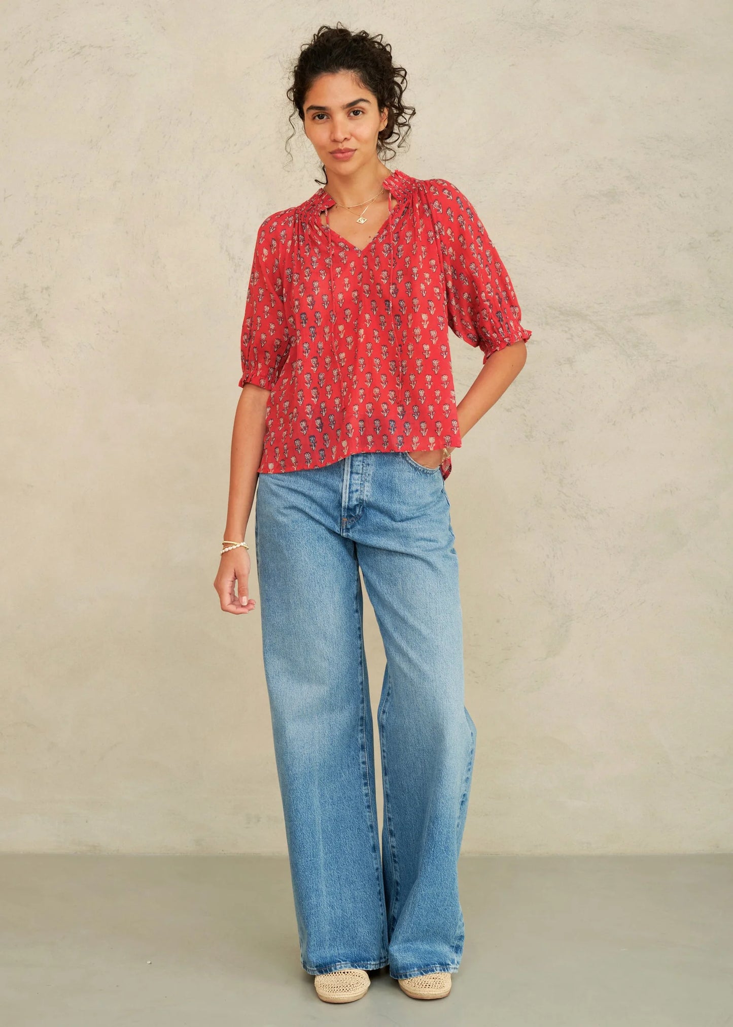 MABE Ari Print short sleeve top in red with small floral pattern, featuring puffy sleeves and V-neckline.