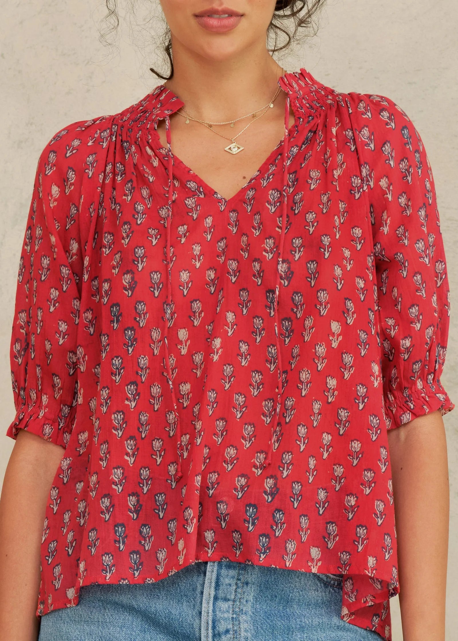 MABE Ari Print short sleeve top in red with small floral print pattern and v-neckline