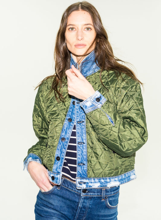 Model wearing olive green quilted liner jacket over denim jacket and striped top
