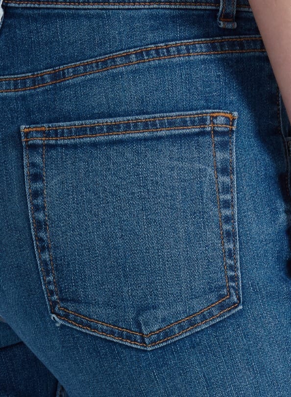 Close-up of back pocket on ASKK Bond Street medium blue wash bootcut jeans