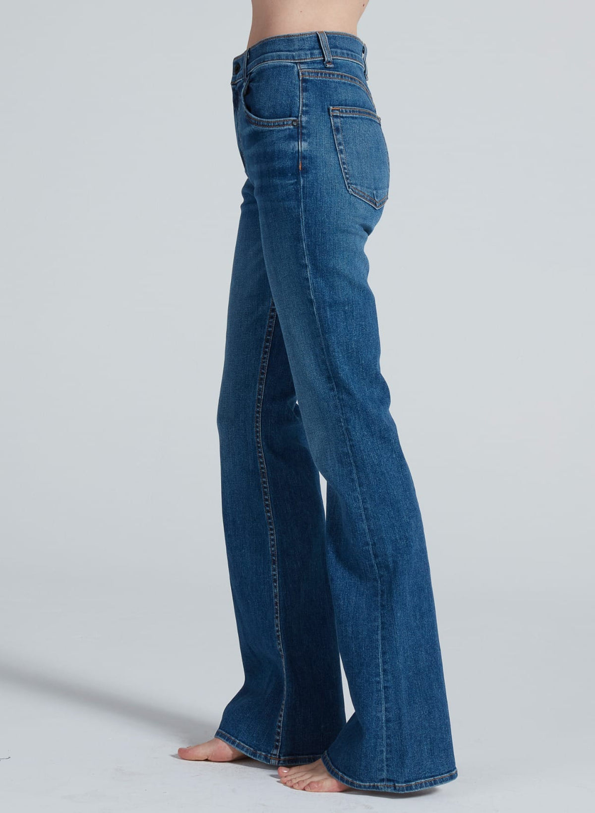 Side view of ASKK Bond Street bootcut jeans in medium blue denim wash