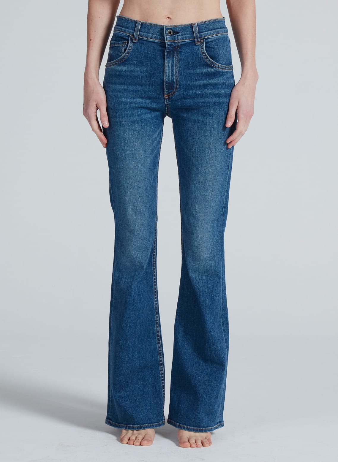 Woman wearing ASKK Bond Street bootcut jeans in medium blue denim wash