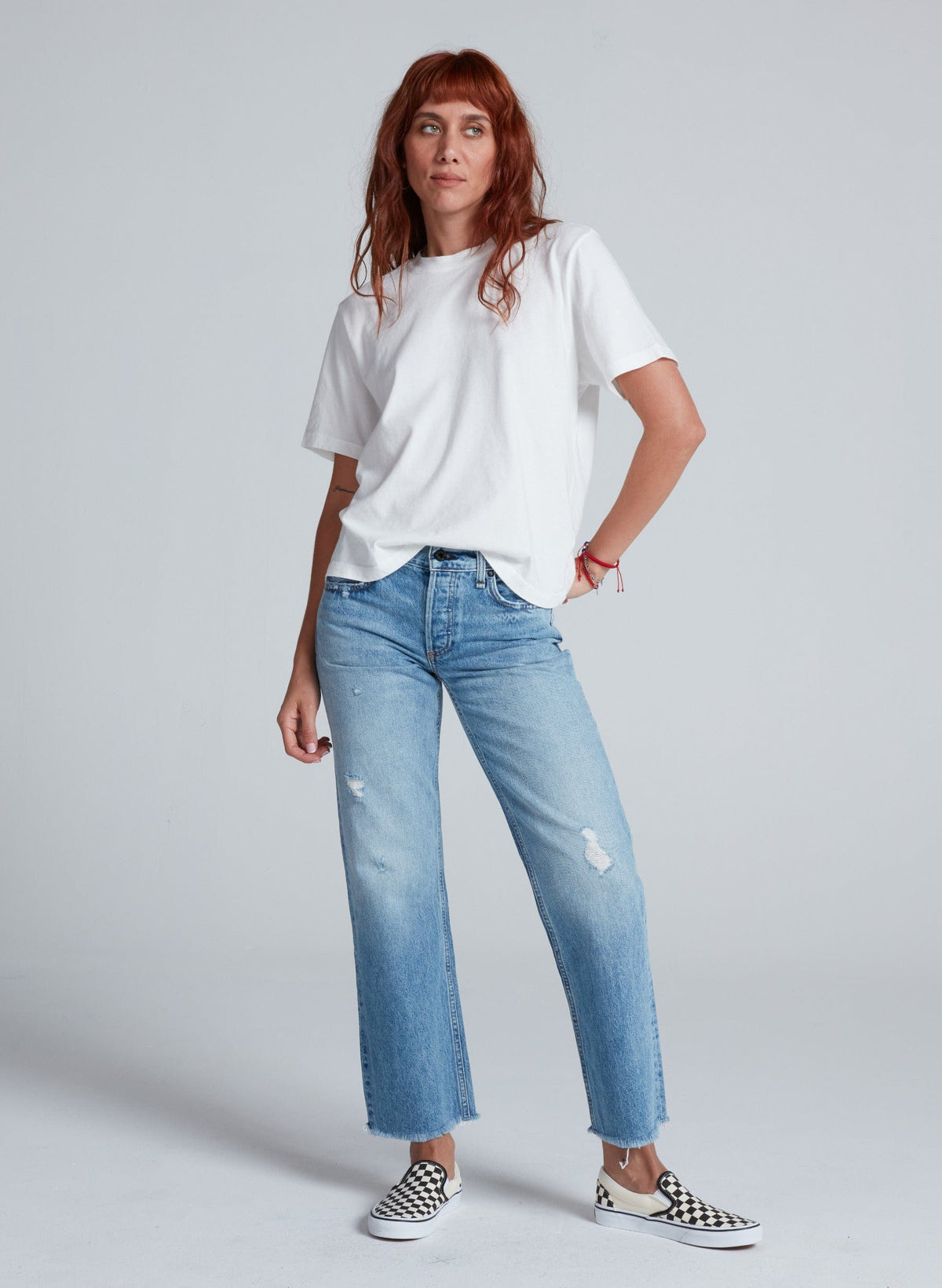 Model wearing ASKK NY low rise straight jeans in light blue Berkeley wash with white tee