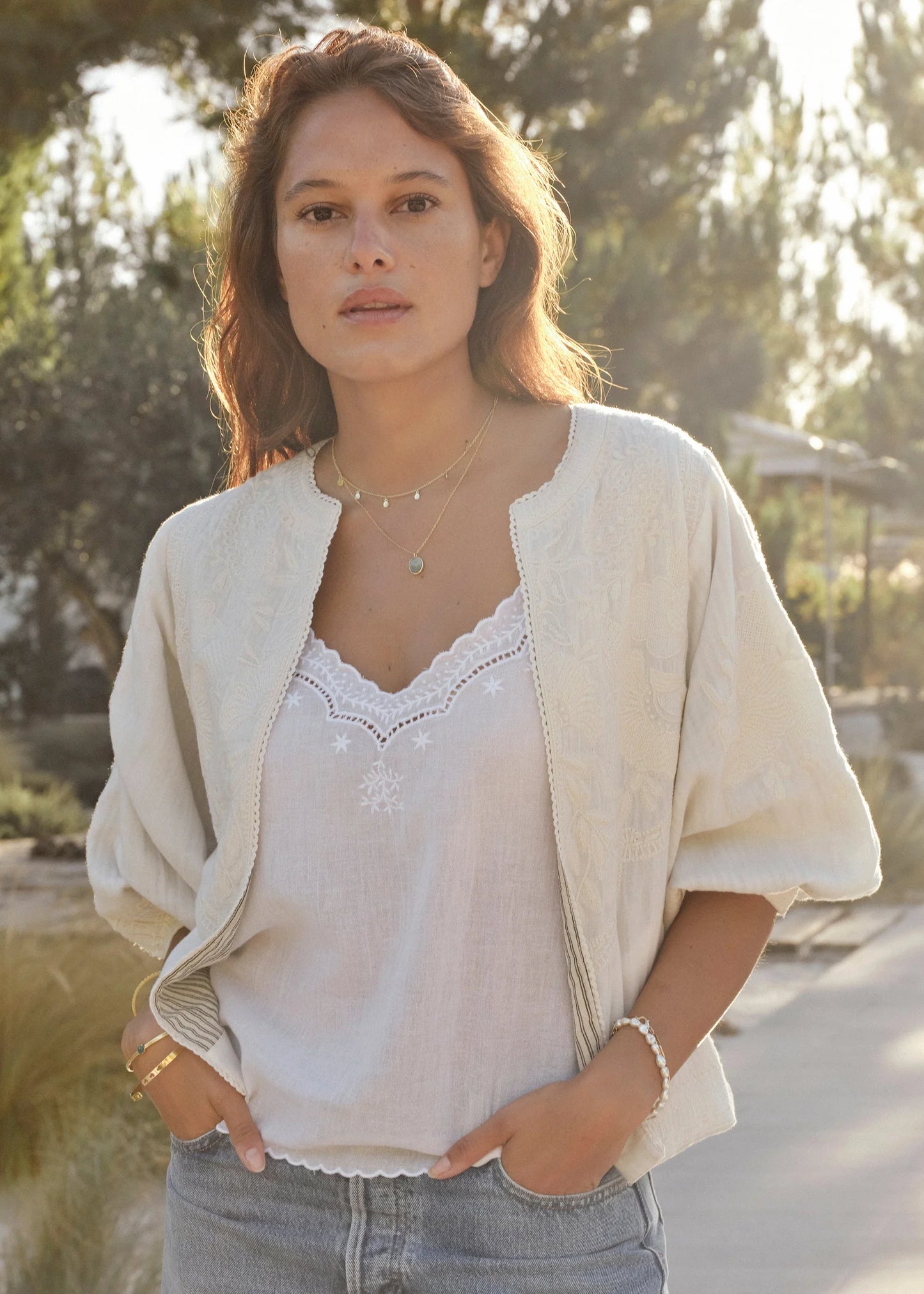 MABE Averi ivory embroidered jacket with open front styling, worn over white lace camisole top.