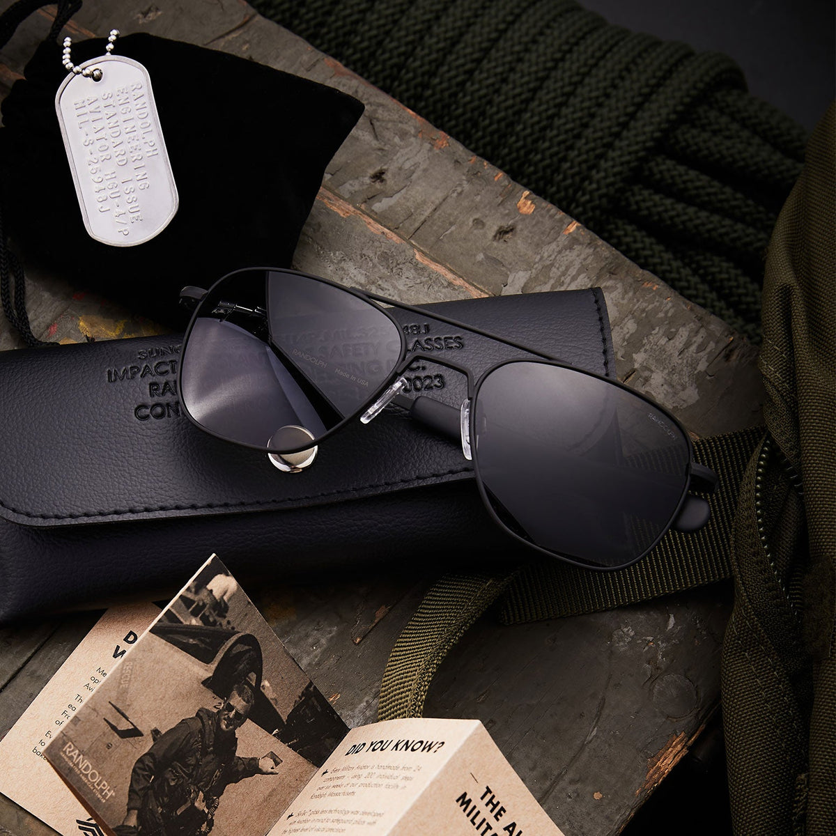 Randolph Military Special Edition matte black aviator sunglasses displayed with military dog tags and leather case