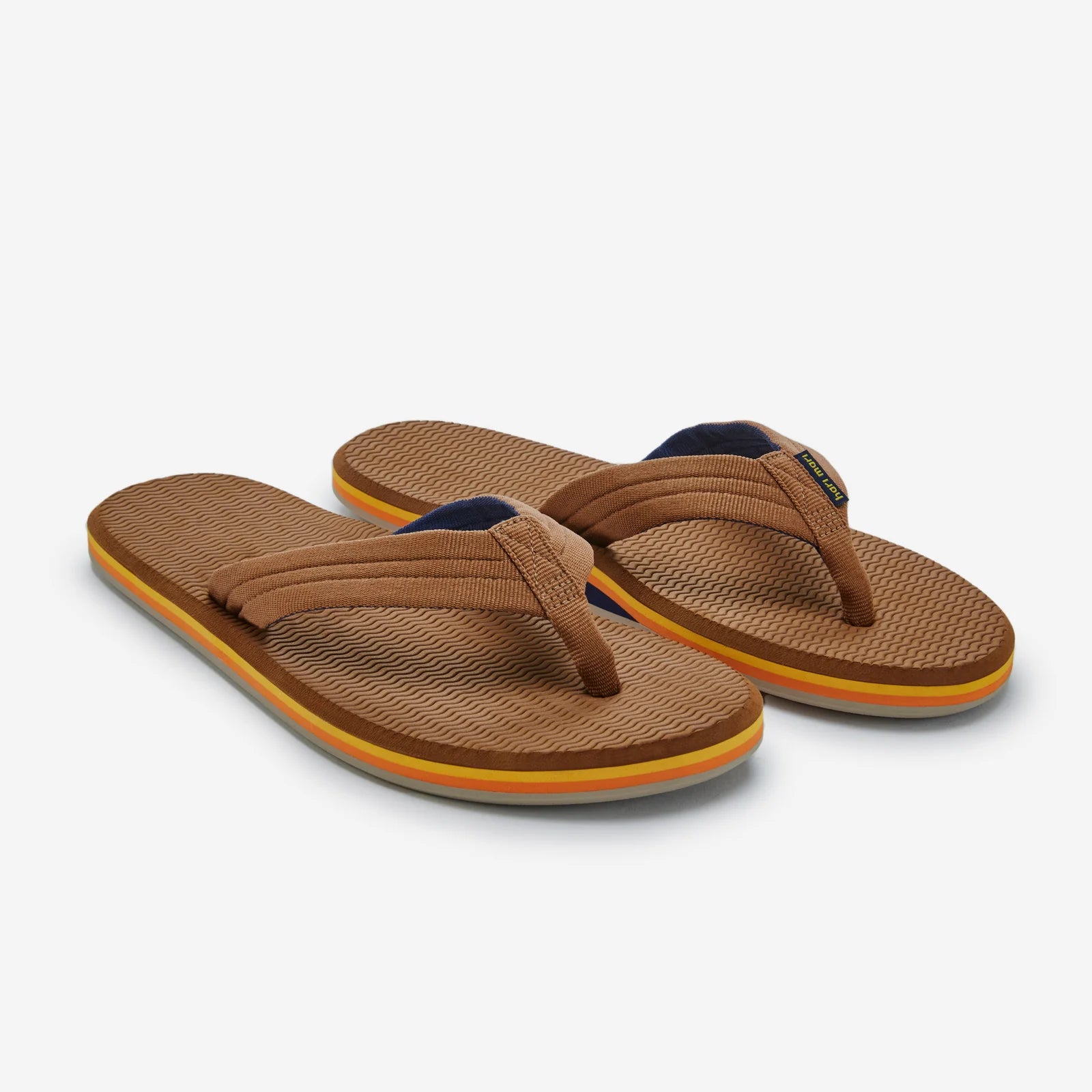 Hari Mari Dunes brown flip-flops with textured footbed, fabric straps, and colorful striped sole edges