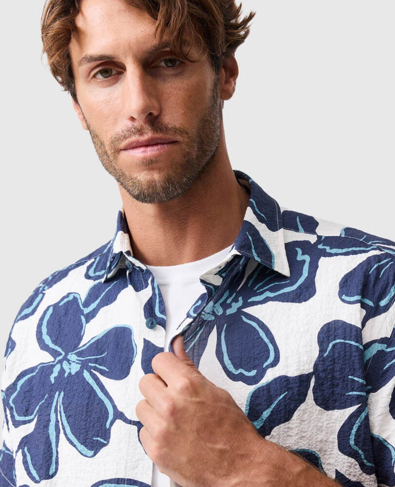 Rodd & Gunn Hamilton Bay short sleeve shirt featuring blue floral print pattern on white background worn by male model.