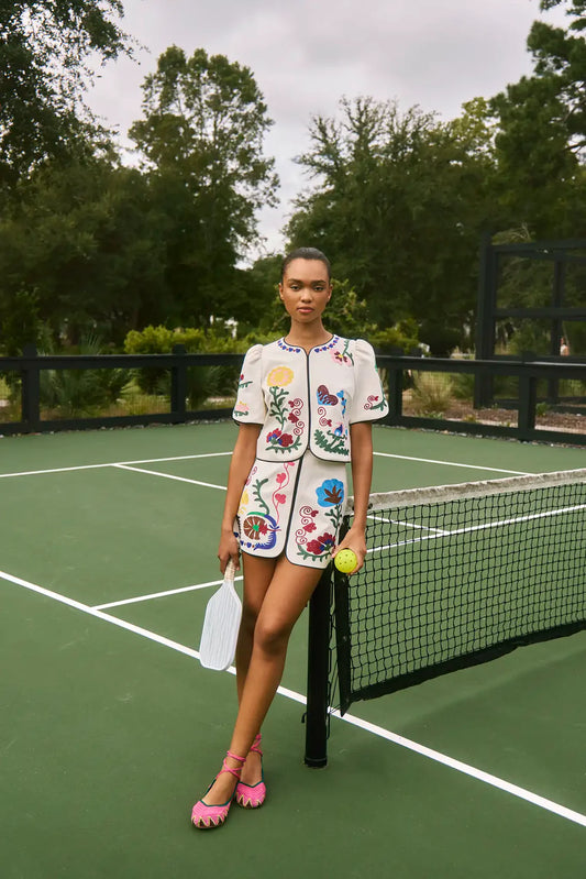 Hunter Bell Beeson embroidered floral top with puff sleeves and colorful botanical motifs on white fabric