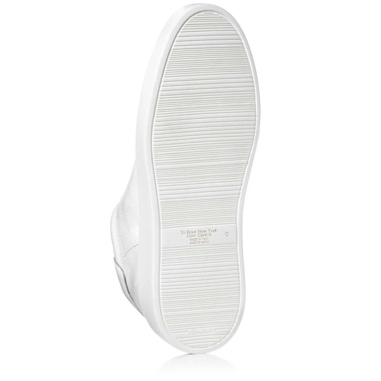 To Boot James white leather sneaker showing textured sole with horizontal grip lines and brand embossing.