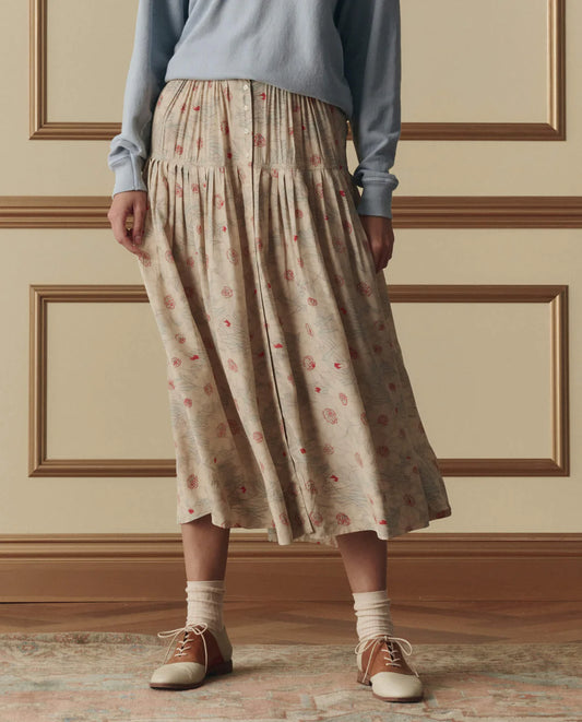 The Great Highland midi skirt in champagne with scattered floral print, featuring button-front closure and tiered silhouette.