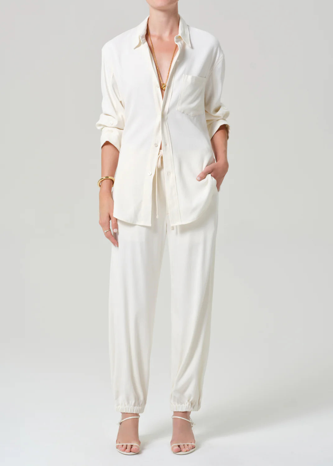 Citizens of Humanity white relaxed-fit pull-on pants in Portofino twill, styled with matching white button-up shirt.