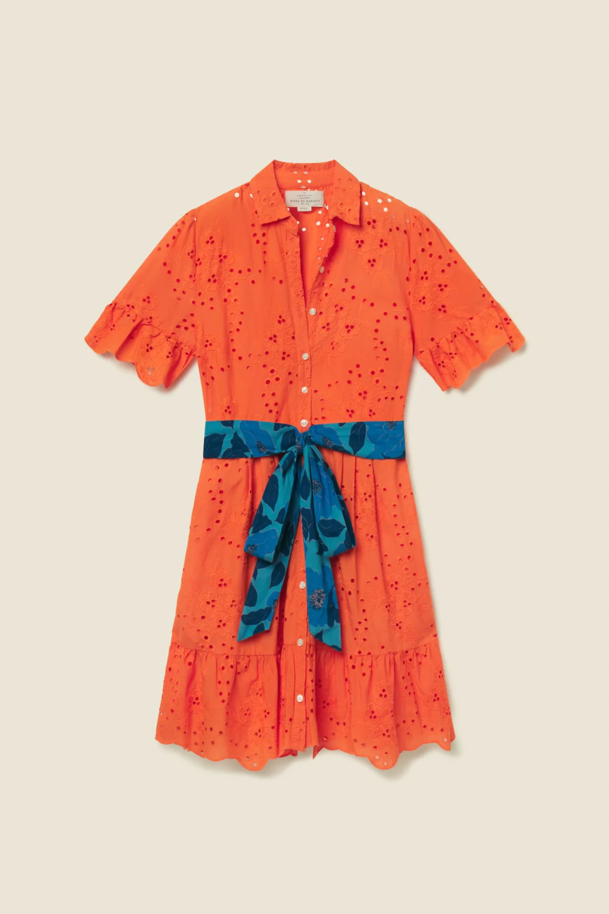 Orange eyelet dress with short sleeves, blue floral belt, button front and ruffle hem