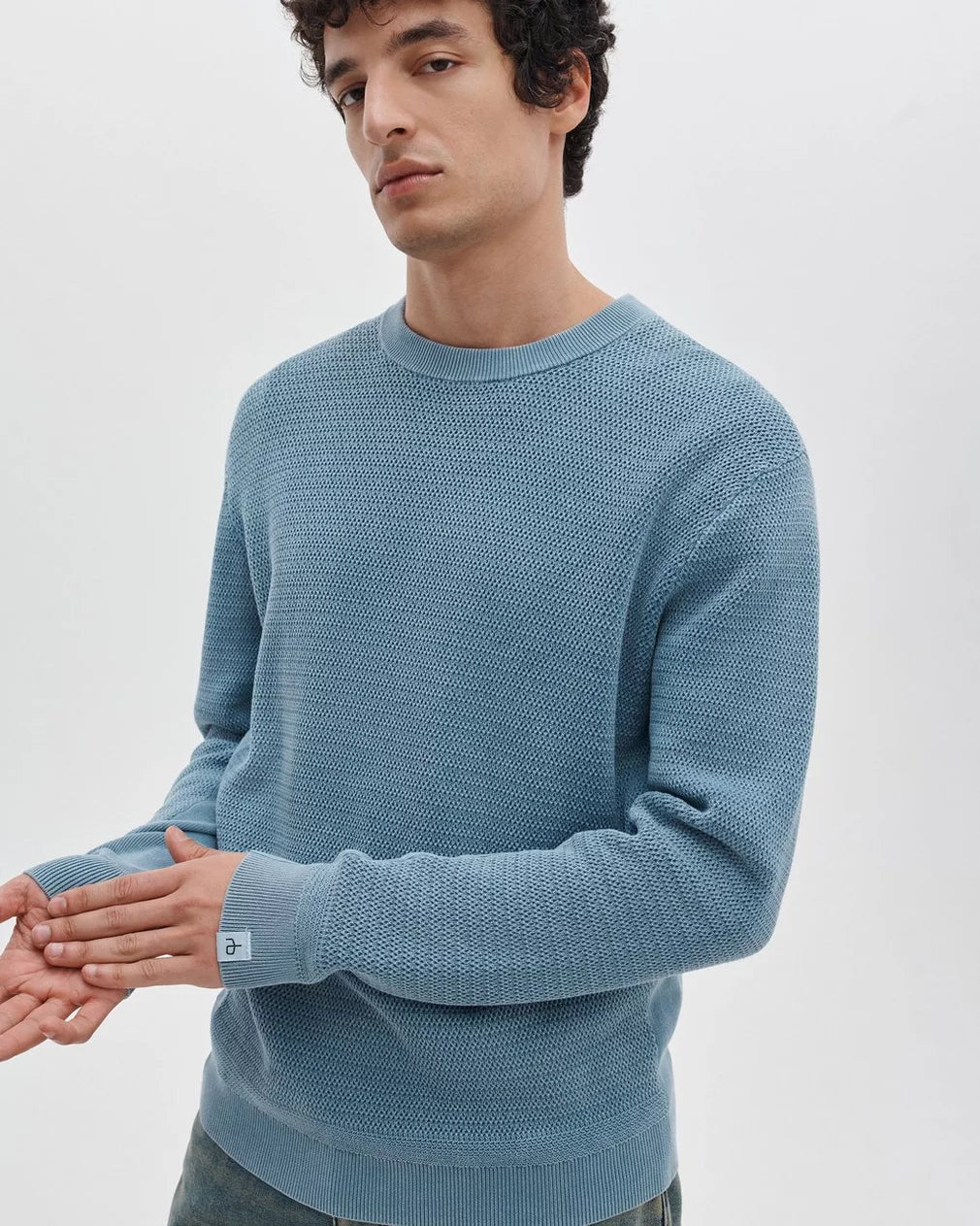 Rag & Bone Caden Washed Crew sweater in fog blue with textured knit pattern on male model